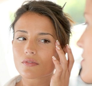 Adult woman touching her skin